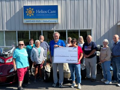 Group of people holding a check and smiling at the camera