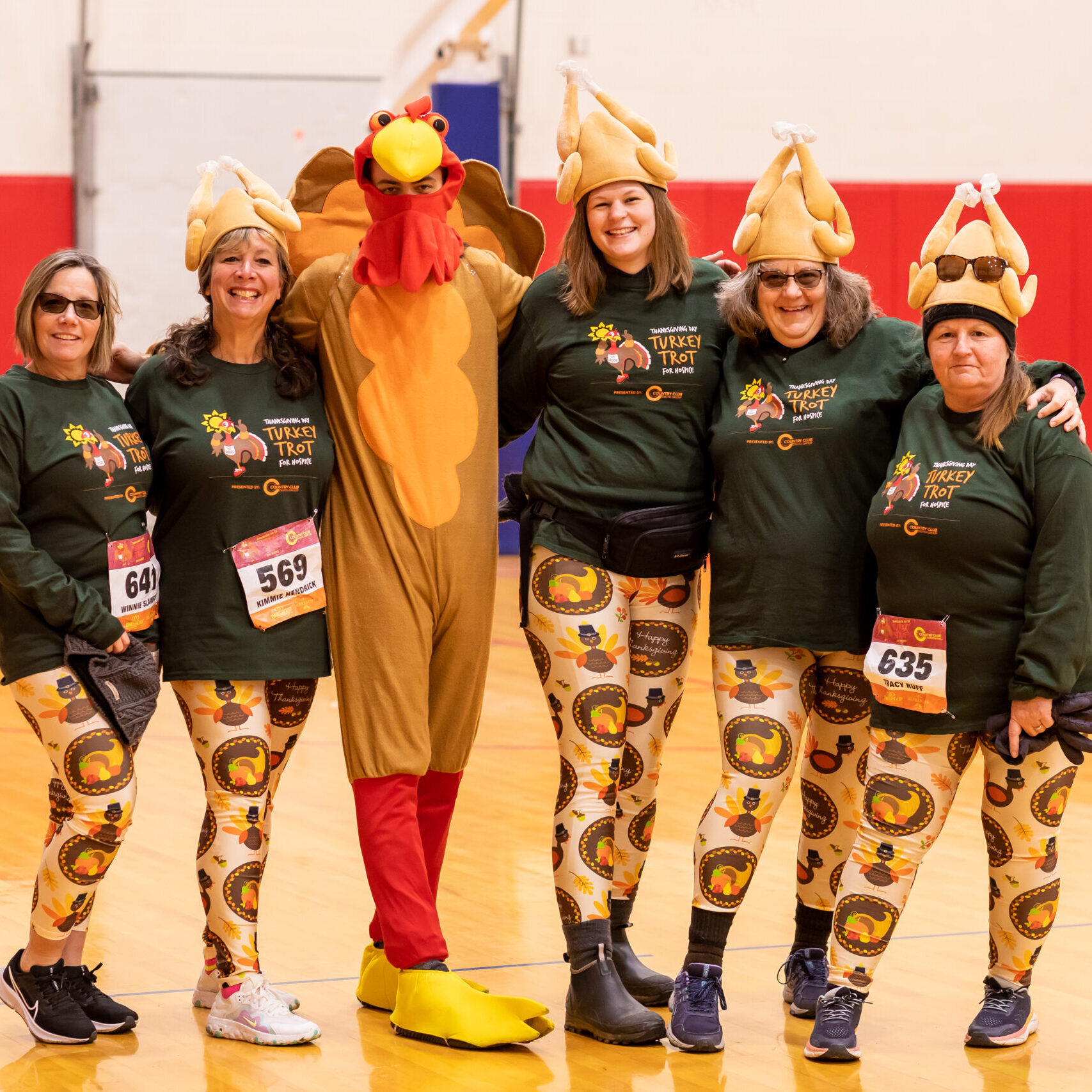 Five people standing with a man in a turkey suit