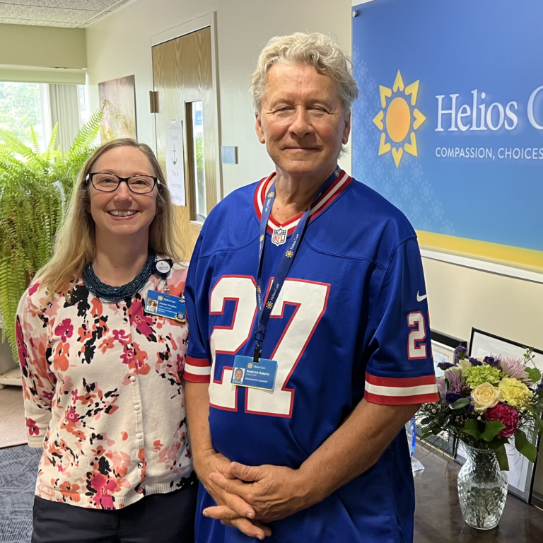 A man and woman smiling at the camera