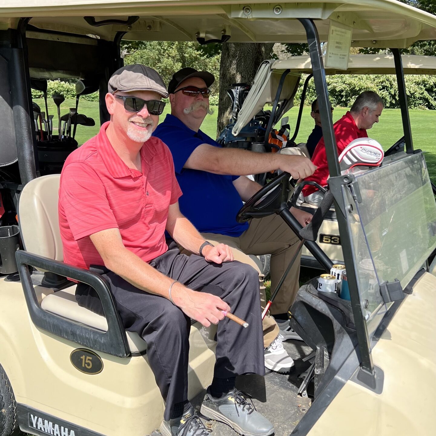 Men sitting in a golf cart