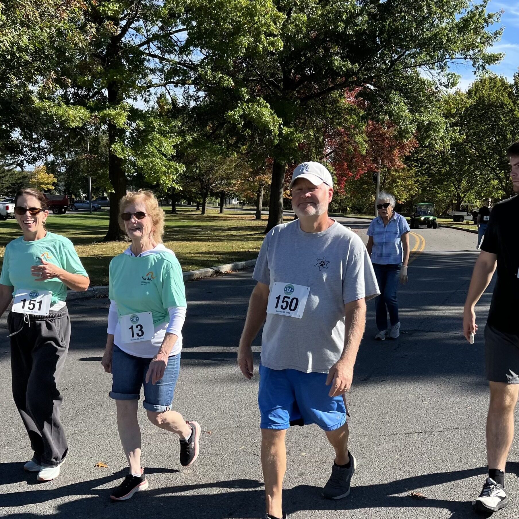 People walking outside under trees