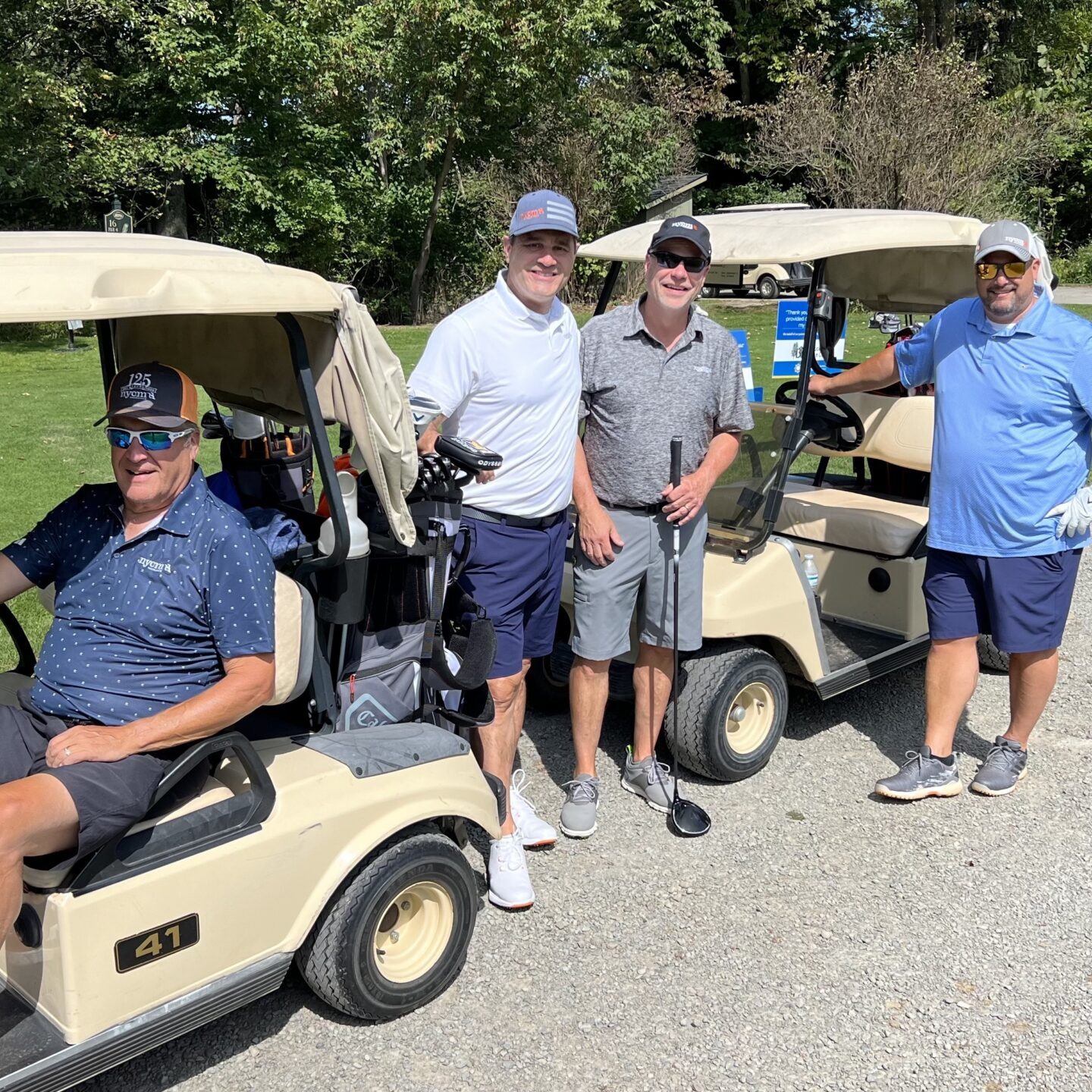 Four men smiling at the camera