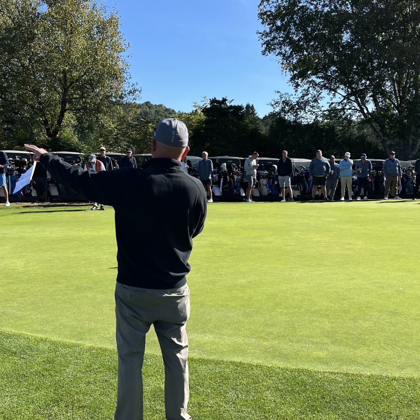 Man standing and talking to people