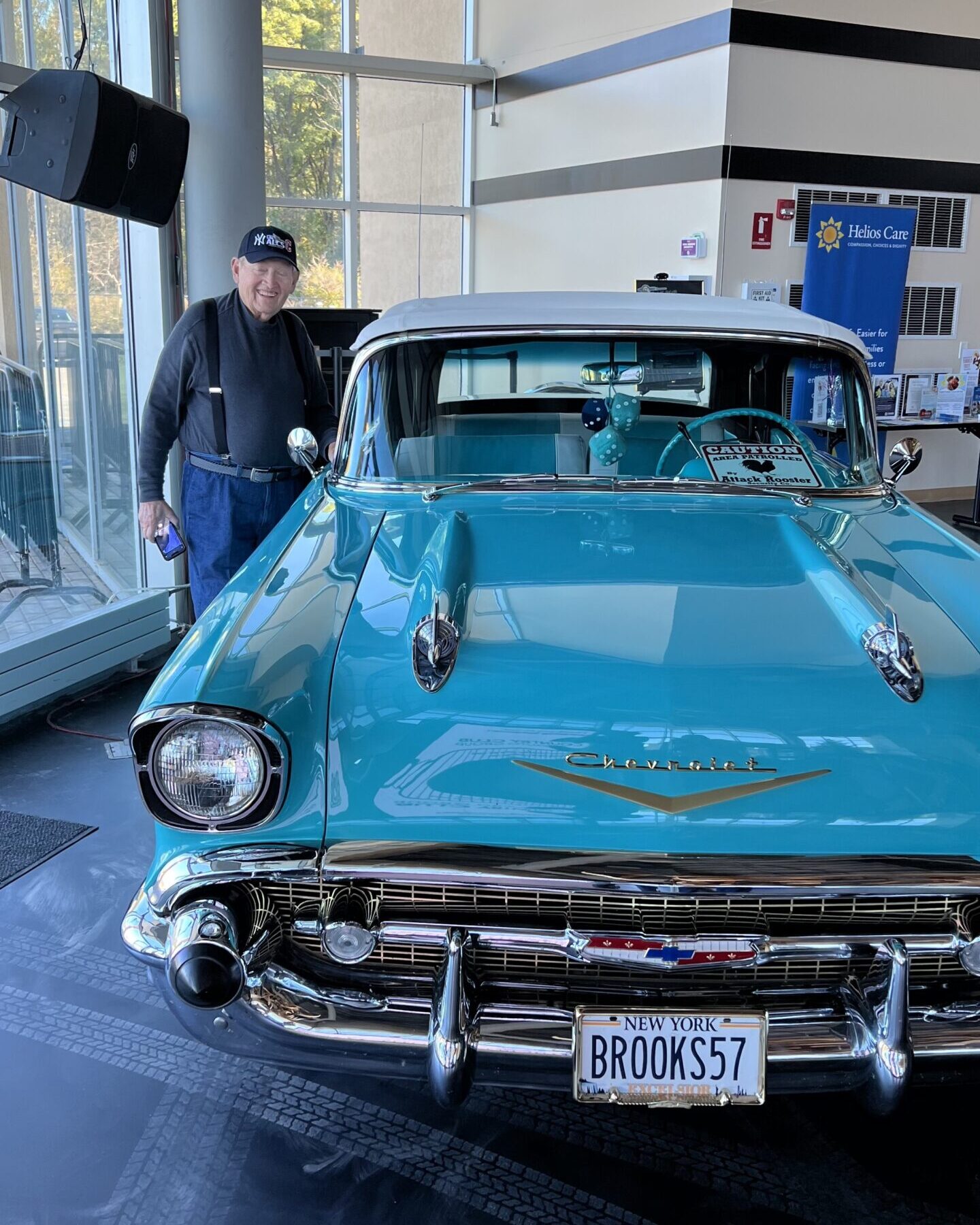 Man standing next to his 1957 Chevy car