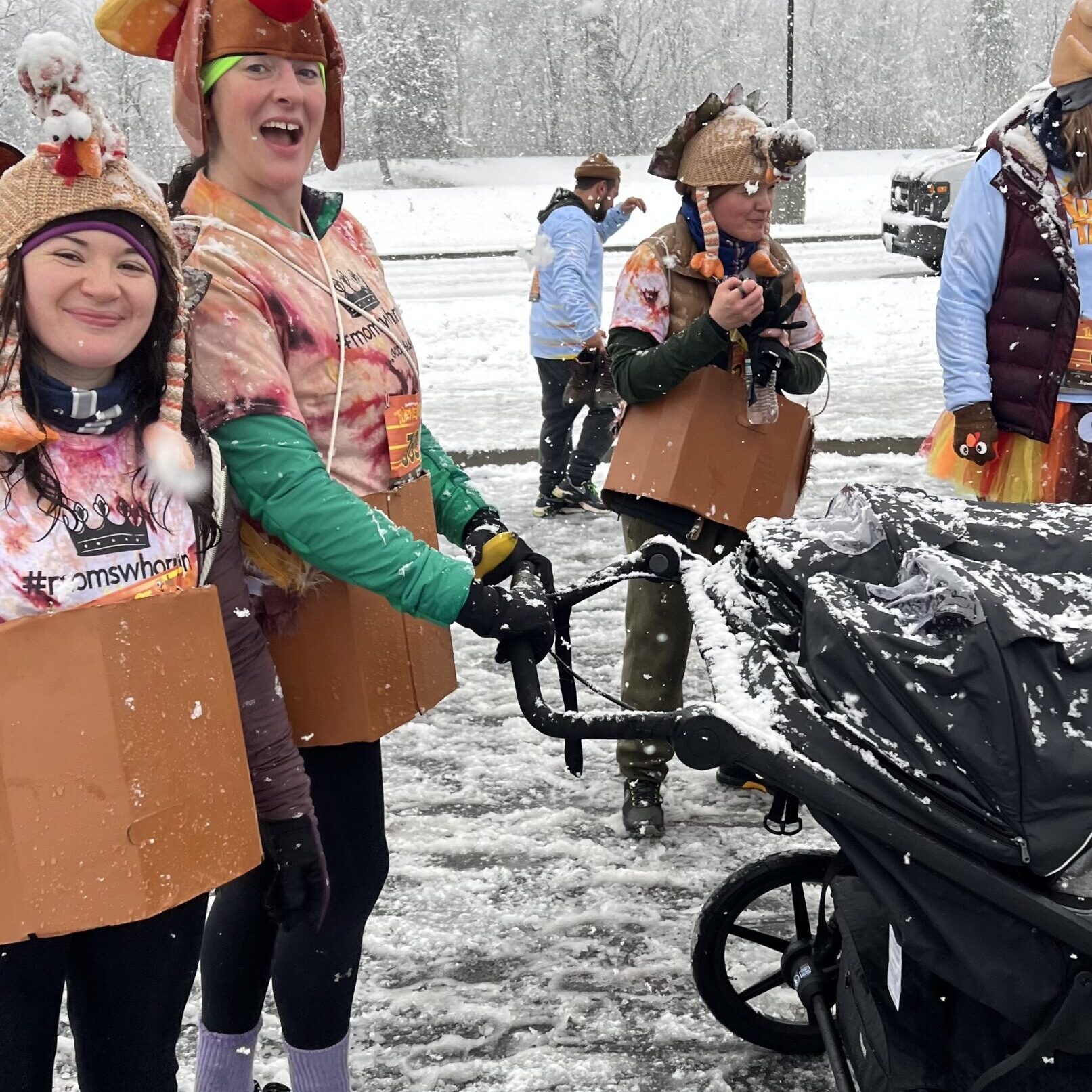 Women pushing a stroller in a turkey costume.