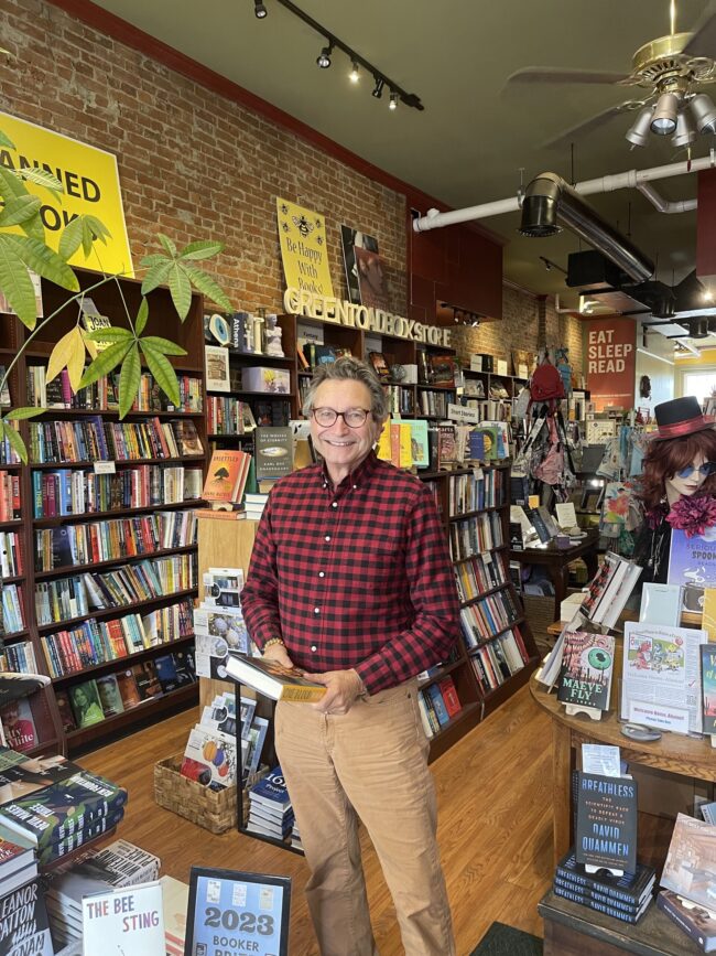 jim havener Man holding a book and standing in bookstore
