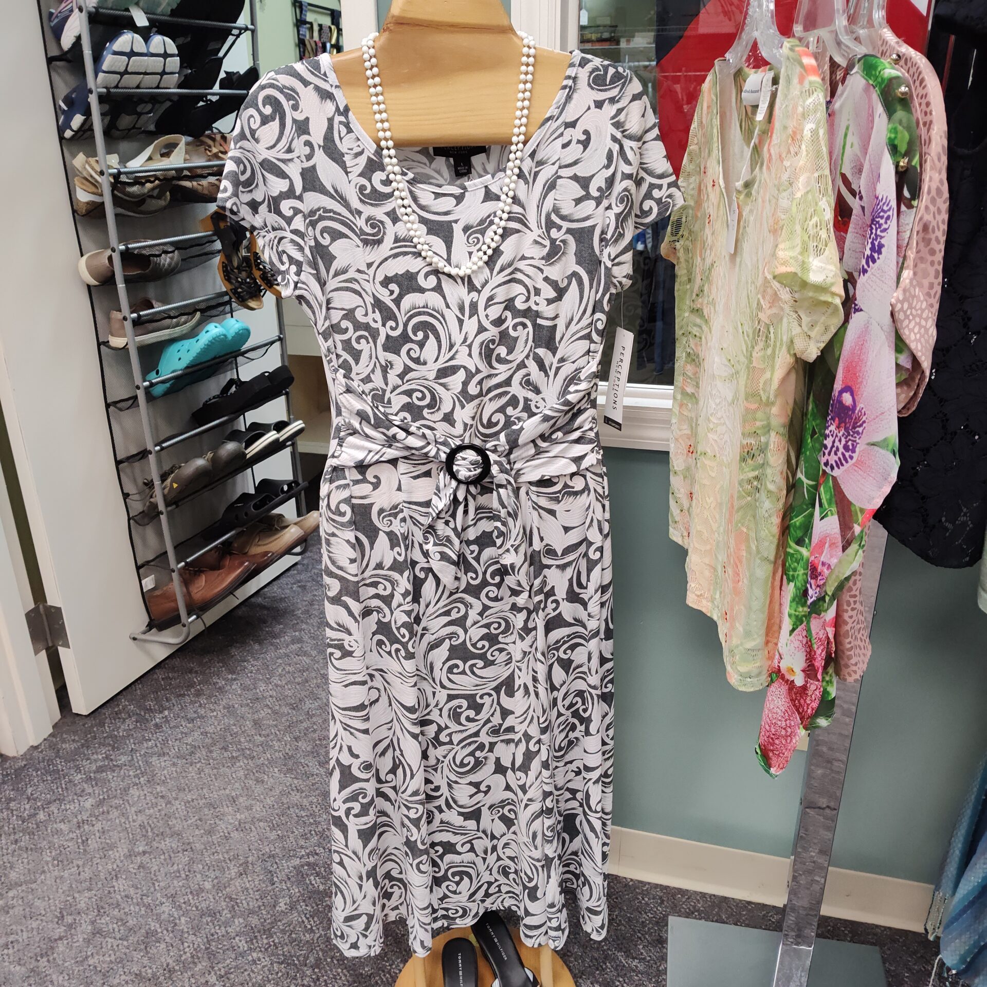 A dress with a matching necklace on a mannequin